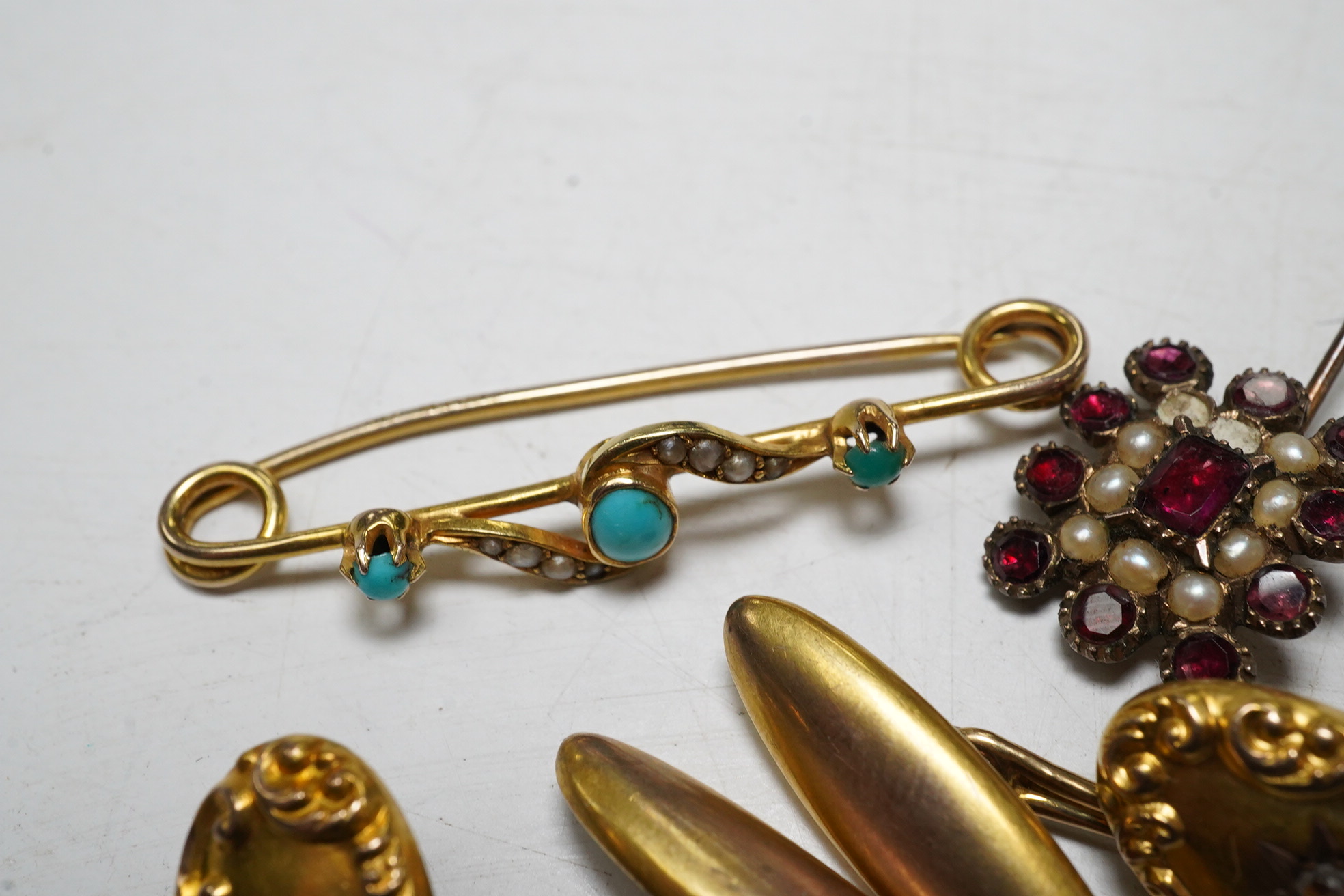 A 15ct gold split pearl and turquoise bar brooch, gross 1.9 grams, a pair unmarked yellow metal cufflinks, each set with an old cut diamond, gross 4.3 grams and an early Victorian garnet and pearl set mourning brooch. Co